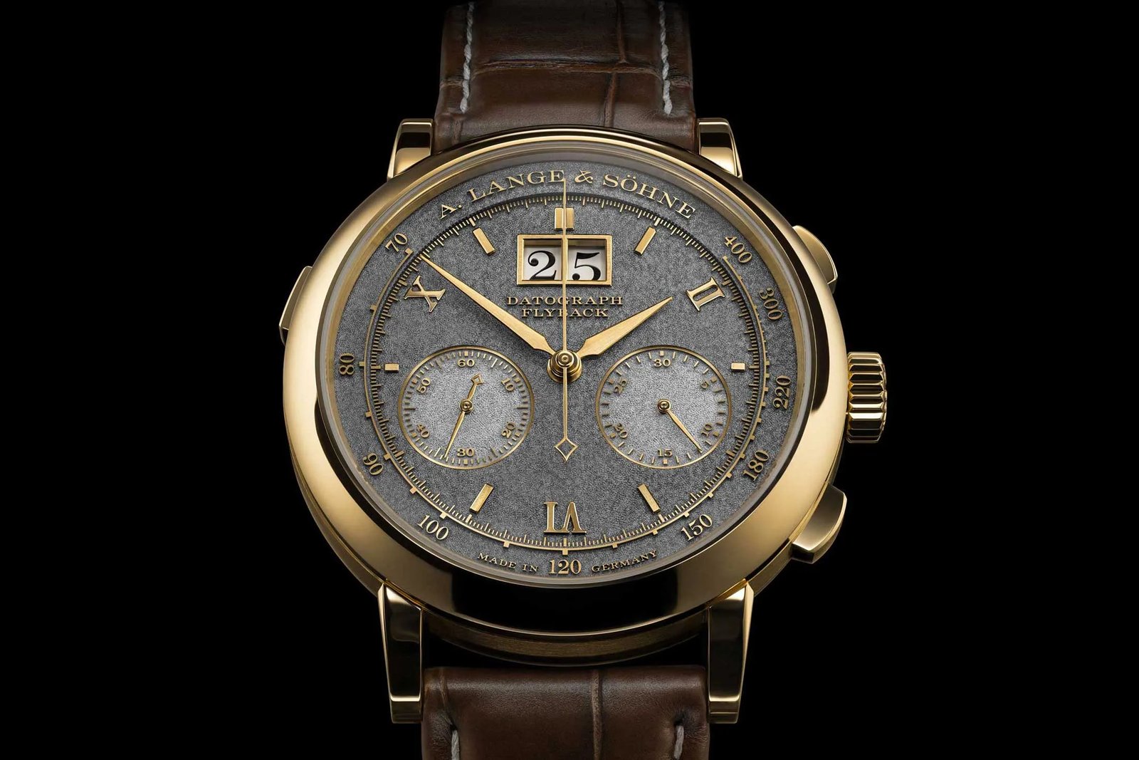 A luxury A. Lange & Söhne watch resting on a polished wooden surface.