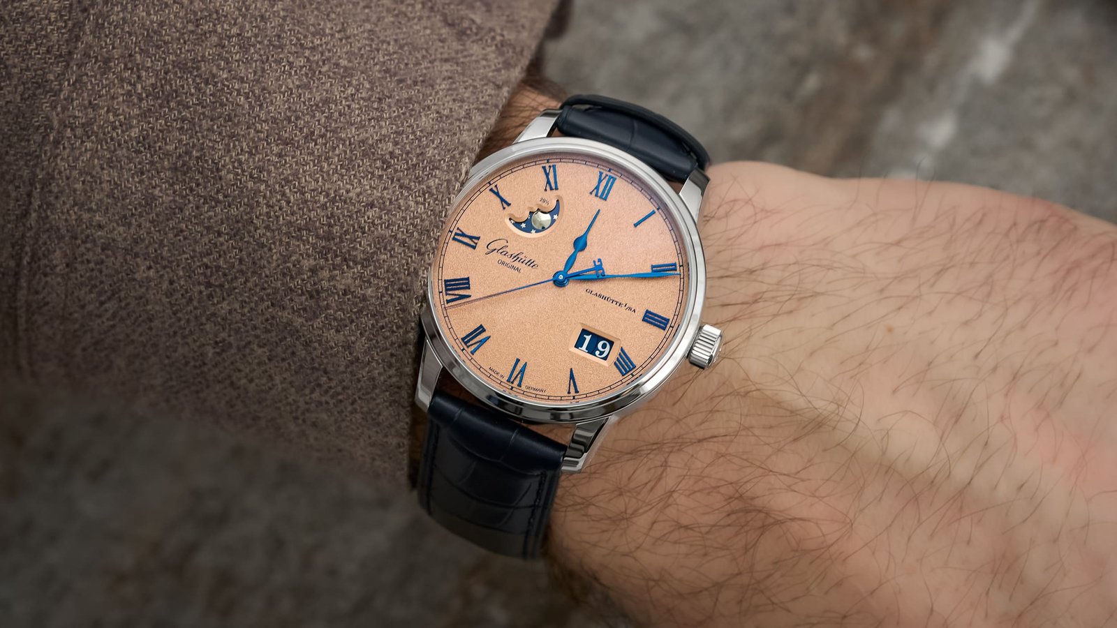 A luxury Glashütte Original watch sits on a desk showcasing fine German watchmaking.