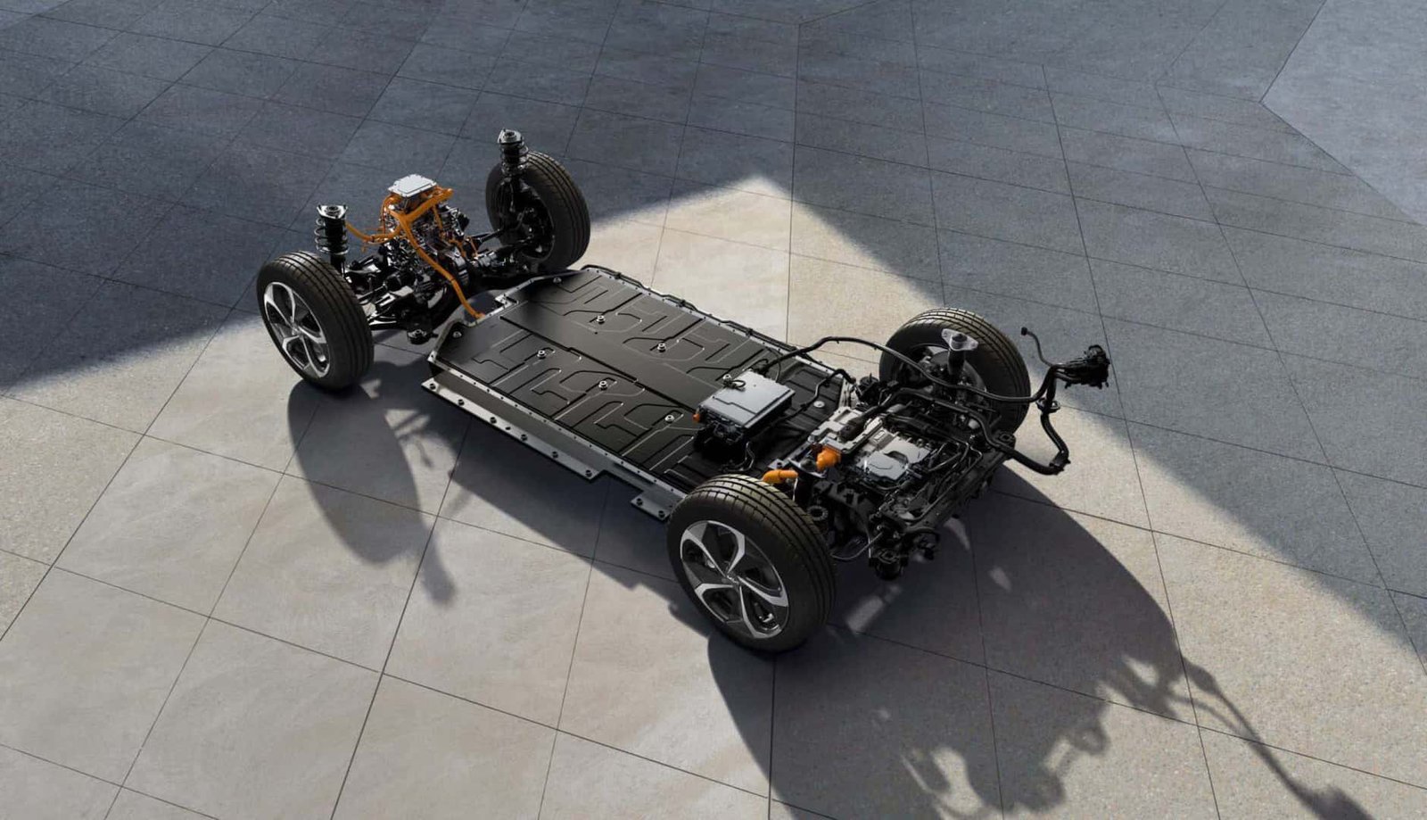 A modern Genesis car battery sits inside the clean engine bay of a luxury vehicle.