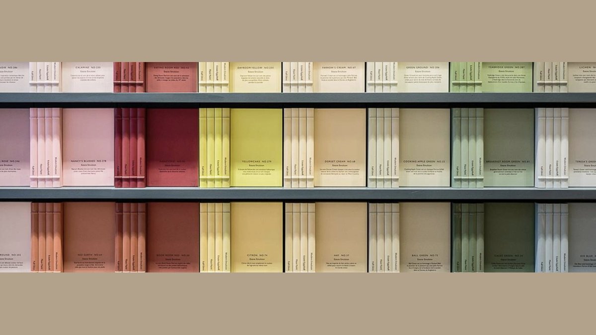 A luxury paint tin sits on a wooden table to illustrate Farrow and Ball paint.