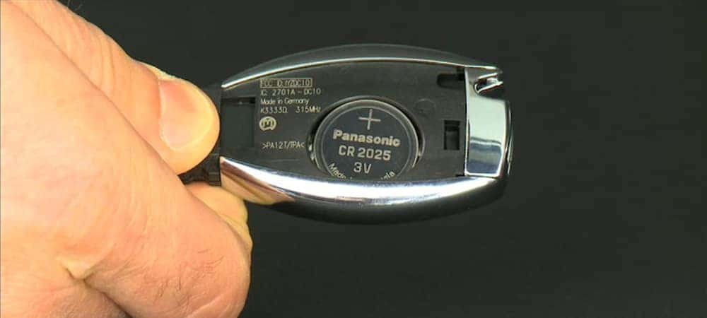 A Mercedes Benz key fob with tools for changing the battery.