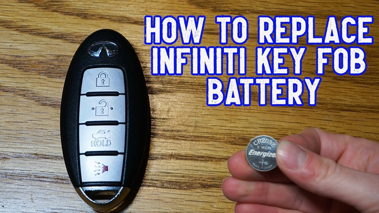An Infiniti key fob disassembled on a workbench for a battery replacement project.