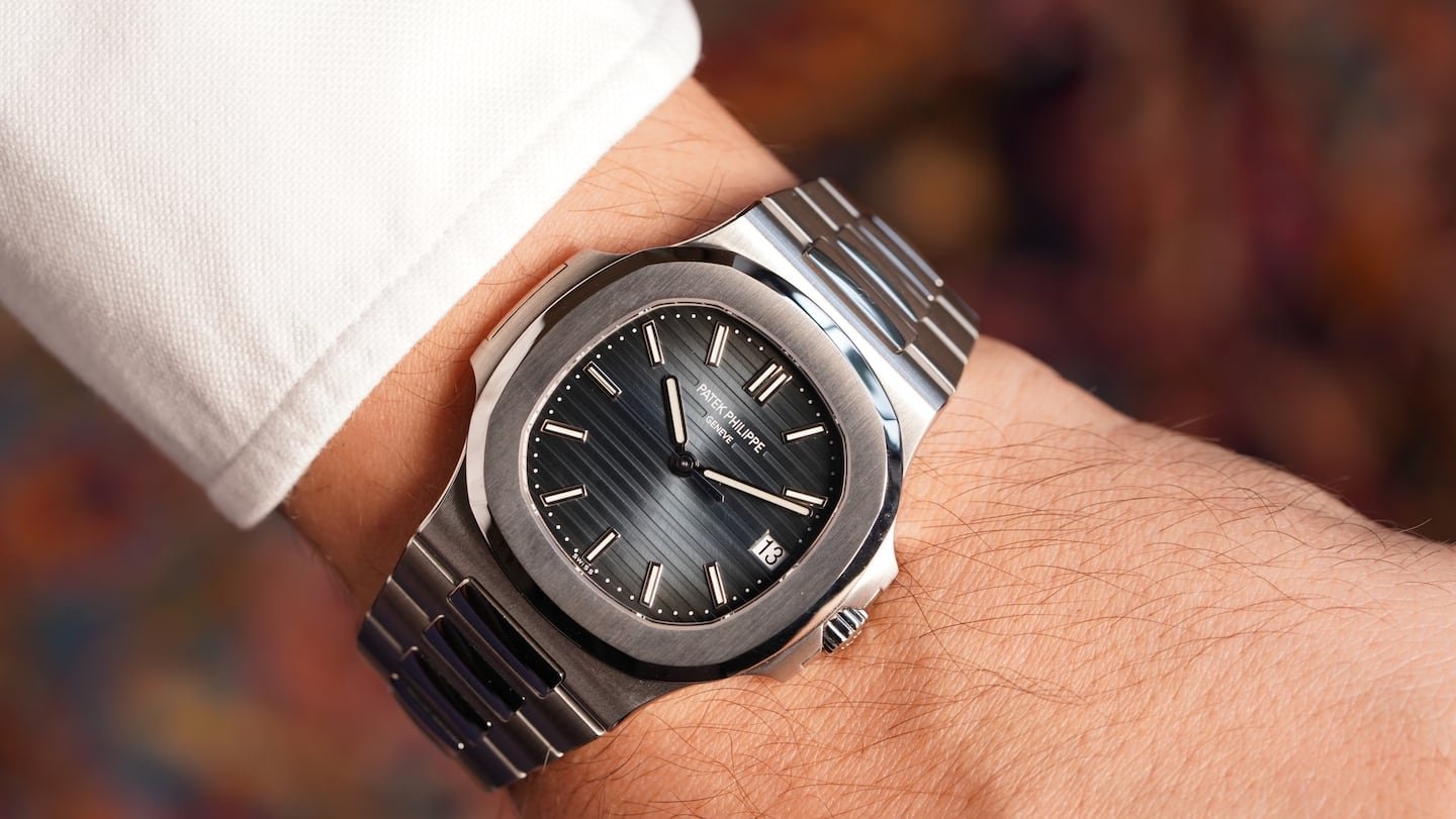 A luxury Patek Philippe watch displayed on a sleek marble surface.