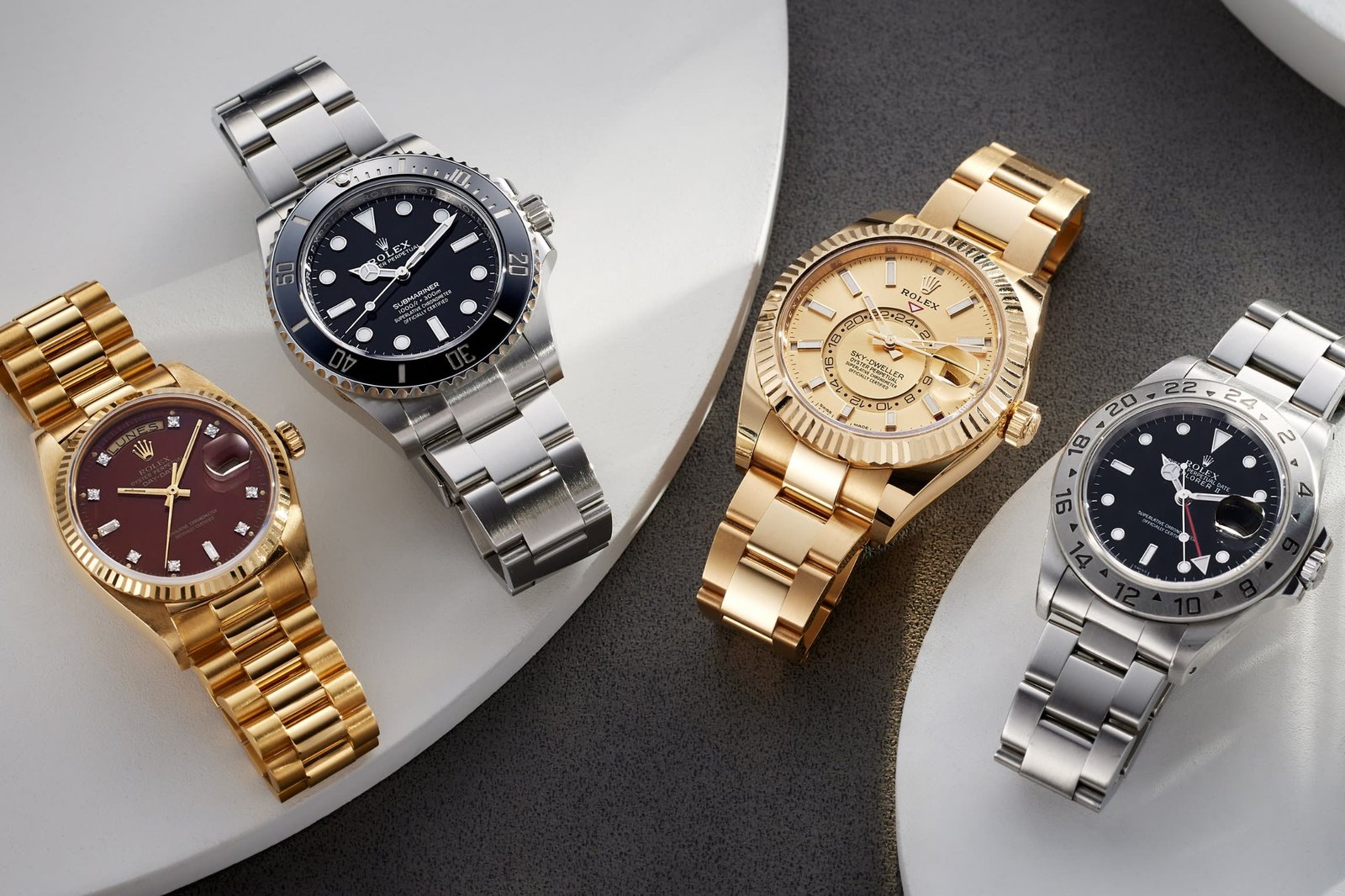 An elegant luxury Swiss mechanical watch resting on a polished dark wood desk.